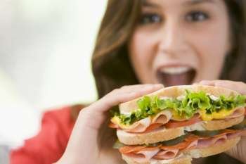 Teenage Girl Eating Sandwich 