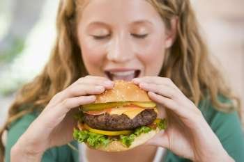 Teenage Girl Eating Burgers 