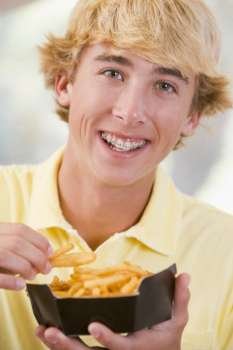 Teenage Boy Eating French Fries 