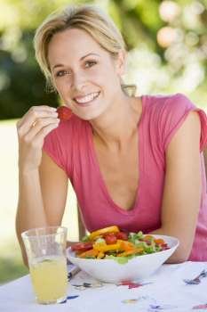 Woman Enjoying A Salad In A Garden