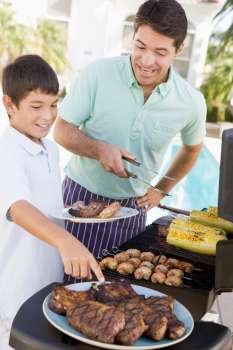 Father And Son Barbequing