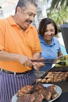 Couple Cooking On A Barbeque