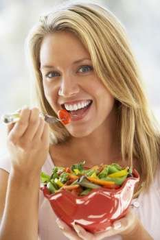 Young Woman Eating Fresh Salad