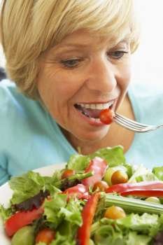 Middle Aged Woman Eating Healthy Salad