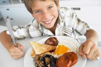 Young Boy Eating Unhealthy Fried Breakfast