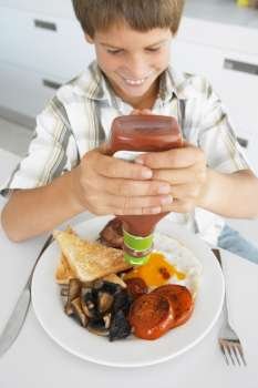 Young Boy Eating Unhealthy Fried Breakfast