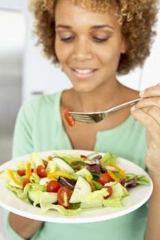 Mid Adult Woman Eating A Healthy Salad