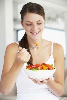 Young Woman Eating A Healthy Salad