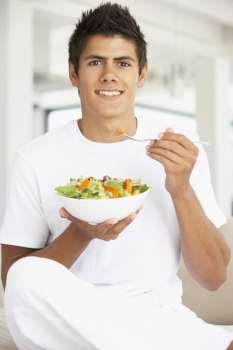 Young Man Eating A Salad