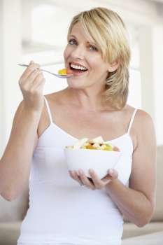 Mid Adult Woman Eating Fresh Fruit Salad