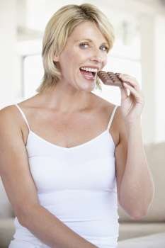 Mid Adult Woman Eating Chocolate
