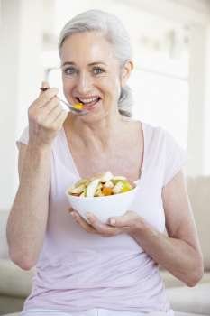 Senior Woman Eating Fresh Fruit Salad