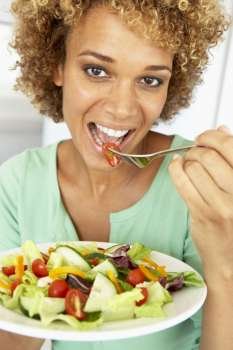Mid Adult Woman Eating A Salad