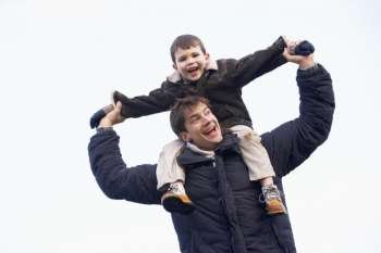 Father Carrying Son On His Shoulders