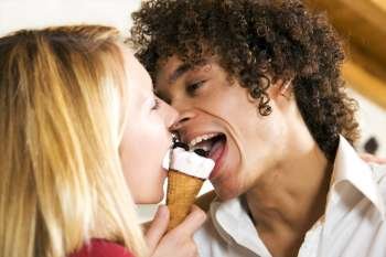 domestic life: interracial couple sharing an ice cream