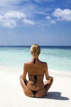 tropical beach: perfect girl meditating on a tropical beach. Copy space 