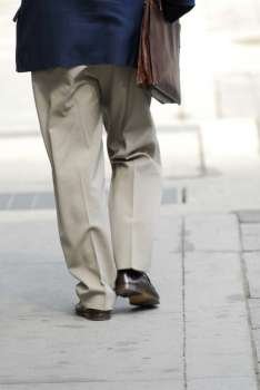 Businessman walking on a busy street downtown