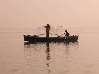 Two fishers on boat, Ganges, Varanasi, India