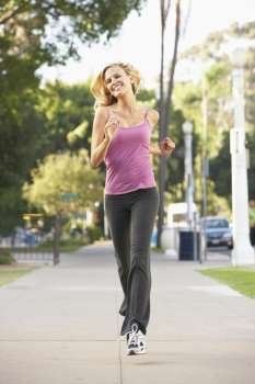 Young Woman Jogging On Street