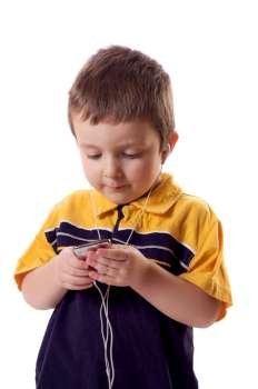 Cute little boy listening to music with earphones 