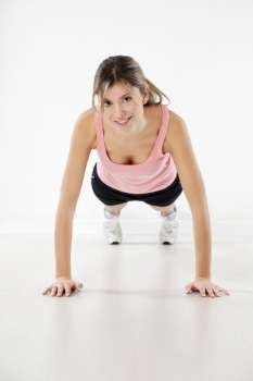 front view of young woman doing push-ups 