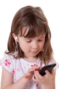 Cute little girl holding a mp3 player and listening to music 