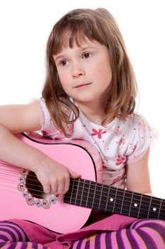Cute little girl holding a guitar 