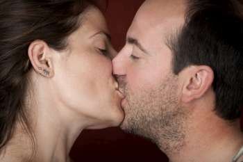 Closeup of pretty woman and handsome man kissing