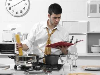 business man in the kitchen preparing dinner