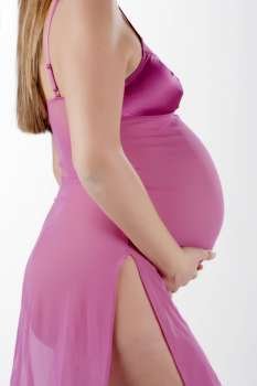 Image of pregnant woman touching her belly with hands 