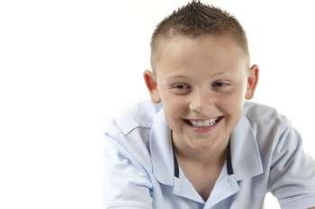 young boy smiling on white background with space for copy
