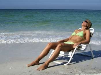 a woman sunbathing in a chair