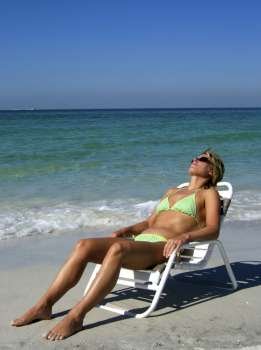 a woman sunbathing in a chair