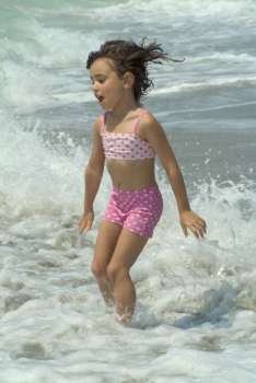 a little girl playing in the sea
