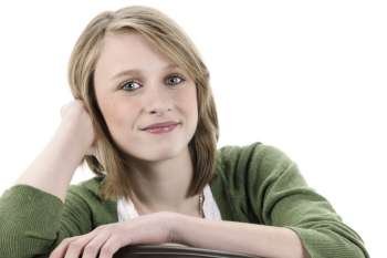 Teenage girl with blonde hair smiling at camera