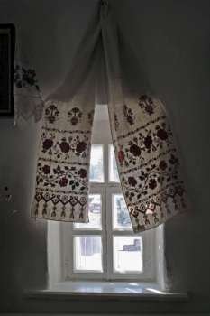 Window decorated by towels with the Ukrainian national patte