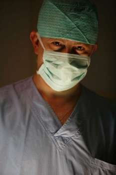 Surgeon looking into lens