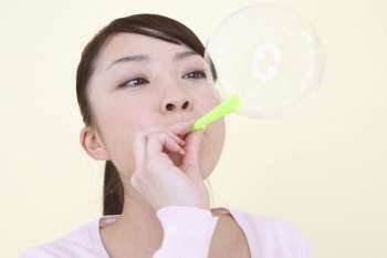 Japanese woman playing with soap bubble