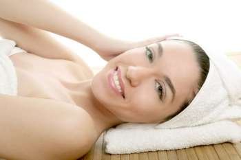 Beautiful woman face massage with towel around her head