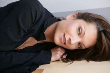 Beautiful blue eyes woman, dress on black. Over a gray stripes background, studio shot