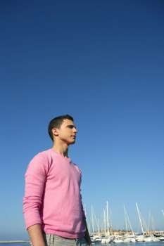 Handsome young man on summer in harbor, blue sky