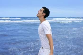 Handsome young man on the blue ocean beach summer sea
