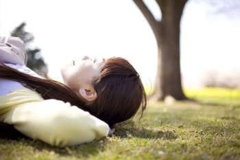 Japanese young woman napping on the ground