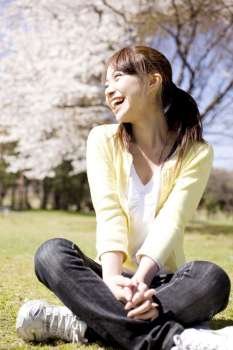Japanese young woman sitting on the ground