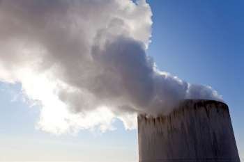 Close up shot of steam or smoke coming from the top of a chimney.