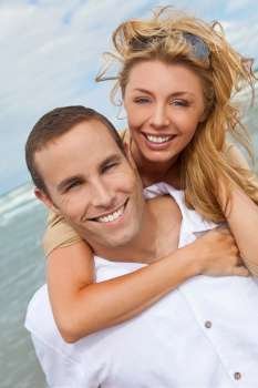 A young man and woman embracing as a romantic couple laughinf and having fun on a beach