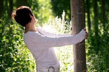 Woman hugging a tree    