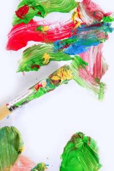 Colorful paint colors on brush over white paper background