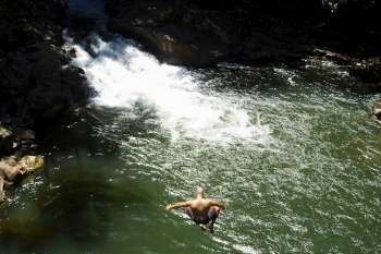 High angle view of a man jumping into a river, Onemea Bay, Big Island, Hawaii Islands, USA