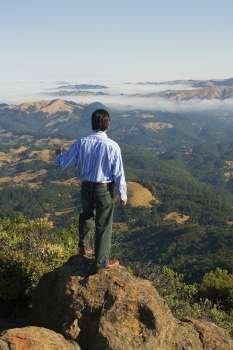 High angle view of a man standing on a hilltop